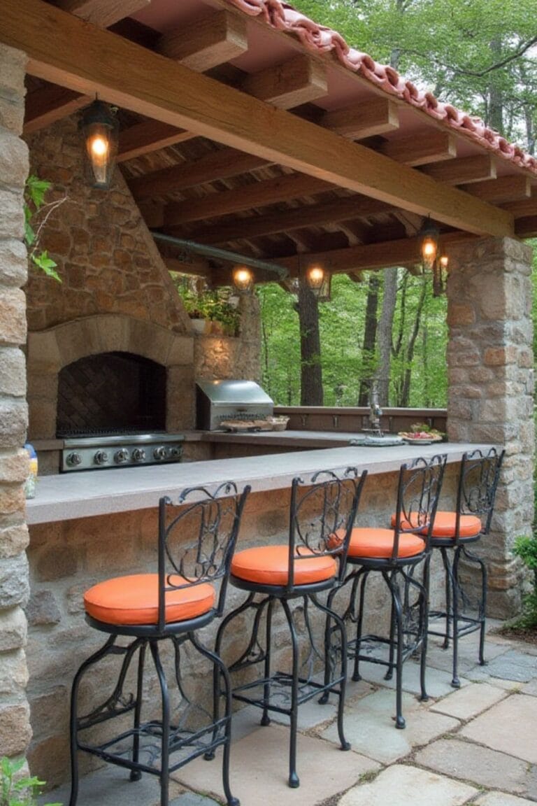 Tuscan-Inspired Outdoor Kitchen with Stone Bar and Wrought Iron Stools